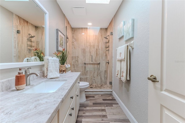 4460 Flounder Dr, Hernando Beach, FL 34607 - bathroom with vanity, a shower stall, wood finished floors, a textured wall, and recessed lighting
