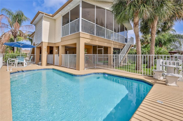4460 Flounder Dr, Hernando Beach, FL 34607 - view of swimming pool featuring a patio, stairs, and a sunroom