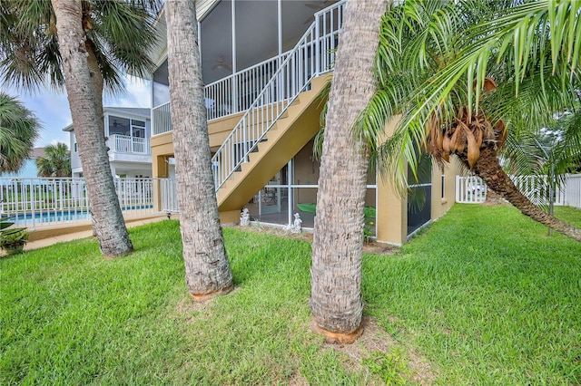 4460 Flounder Dr, Hernando Beach, FL 34607 - exterior space with a sunroom, stucco siding, and a ceiling fan