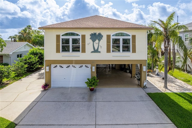 4460 Flounder Dr, Hernando Beach, FL 34607 - coastal home with driveway, an attached garage, and a carport