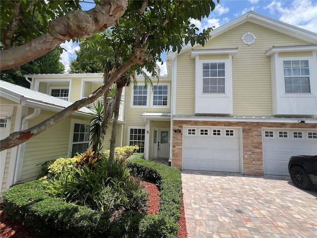 930 Woodbridge Ct, Safety Harbor, FL 34695 - view of front of house featuring driveway, a garage, and stone siding