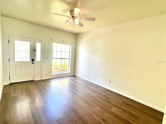 930 Woodbridge Ct, Safety Harbor, FL 34695 - foyer entrance featuring dark wood-type flooring, baseboards, a ceiling fan, and a textured ceiling