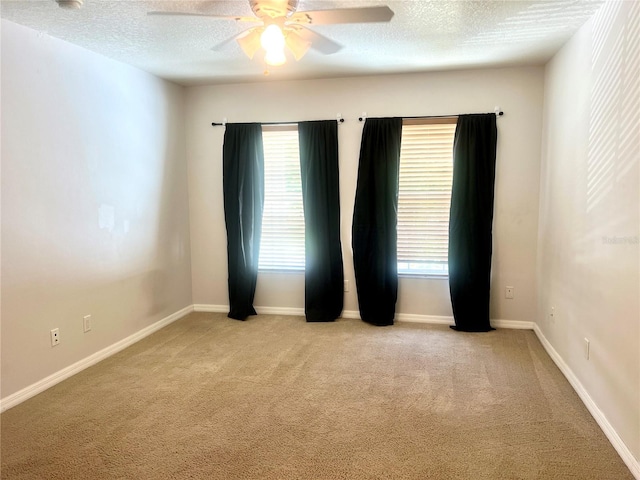 930 Woodbridge Ct, Safety Harbor, FL 34695 - unfurnished room with light colored carpet, ceiling fan, a textured ceiling, and baseboards