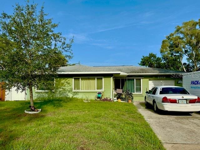 2016 Woodward Ave, Dunedin, FL 34698 - single story home with a garage, concrete driveway, and a front yard