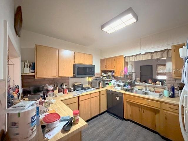 2016 Woodward Ave, Dunedin, FL 34698 - kitchen with dishwasher, light countertops, a sink, and light brown cabinets