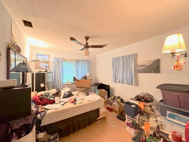 2016 Woodward Ave, Dunedin, FL 34698 - bedroom featuring wood finished floors and ceiling fan