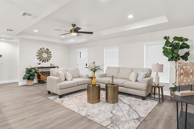 12064 Cradock St, Spring Hill, FL 34608 - living area featuring a raised ceiling, baseboards, light wood-style floors, ceiling fan, and recessed lighting