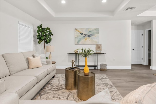 12064 Cradock St, Spring Hill, FL 34608 - living area featuring a tray ceiling, recessed lighting, wood finished floors, and baseboards