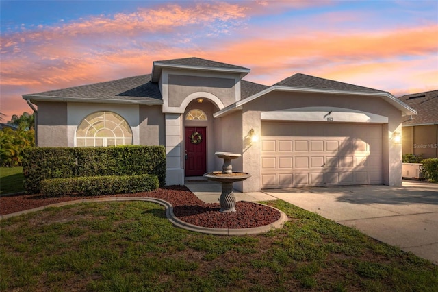 1623 Crossvine Ct, New Port Richey, FL 34655 - view of front facade featuring stucco siding, an attached garage, driveway, and a shingled roof