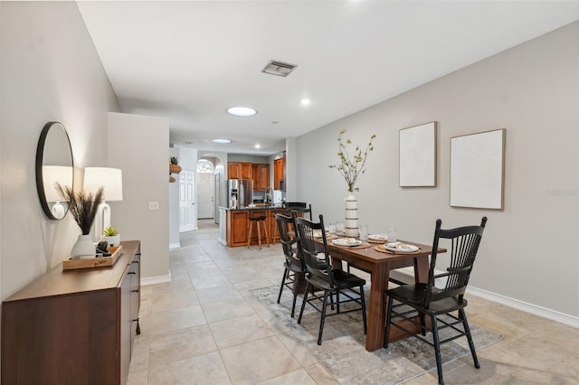 1623 Crossvine Ct, New Port Richey, FL 34655 - dining room featuring arched walkways, recessed lighting, light tile patterned floors, and baseboards
