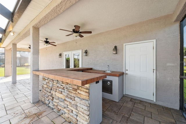 1623 Crossvine Ct, New Port Richey, FL 34655 - view of patio / terrace with ceiling fan, french doors, and exterior kitchen