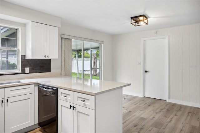 5323 23rd St, Zephyrhills, FL 33542 - kitchen with dishwasher, light wood-style floors, tasteful backsplash, a peninsula, and white cabinets