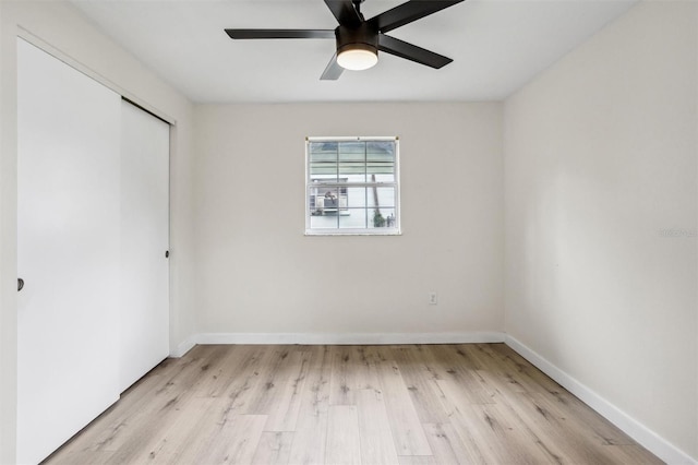 5323 23rd St, Zephyrhills, FL 33542 - unfurnished bedroom with a closet, light wood finished floors, baseboards, and a ceiling fan