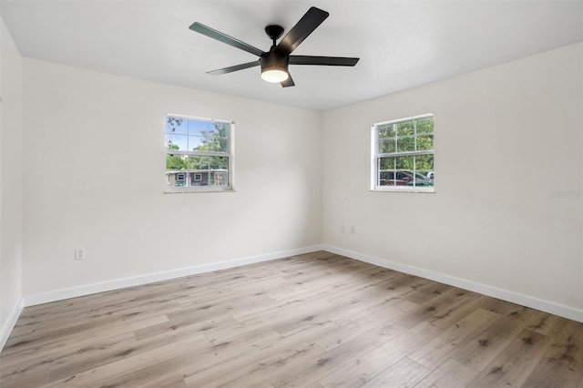 5323 23rd St, Zephyrhills, FL 33542 - spare room with light wood finished floors, baseboards, and a ceiling fan