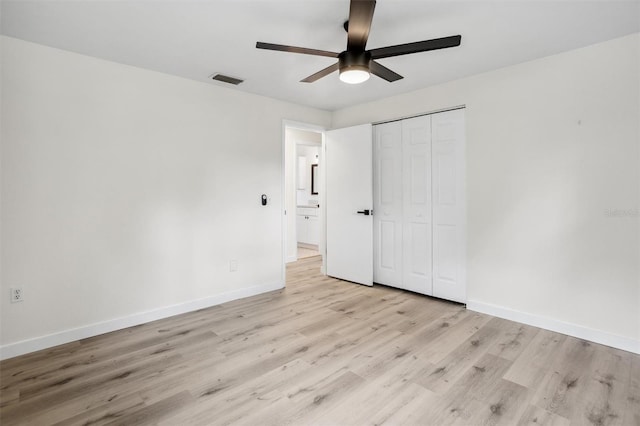 5323 23rd St, Zephyrhills, FL 33542 - unfurnished bedroom featuring light wood-style floors, baseboards, a closet, and ceiling fan