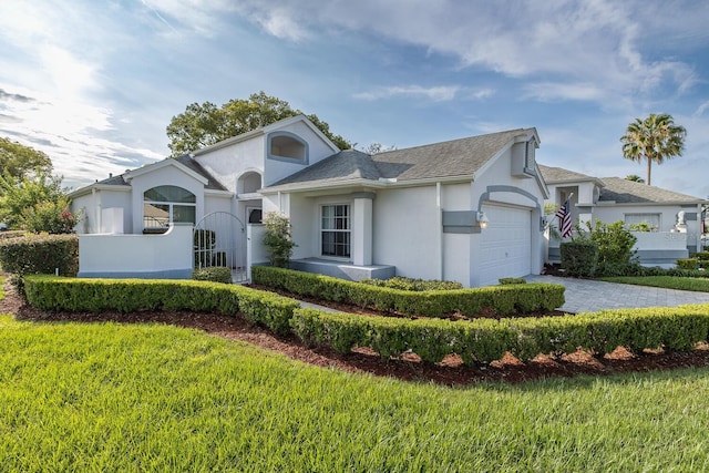 1084 Vista Fina Ct, Spring Hill, FL 34608 - view of front of house with an attached garage, stucco siding, driveway, a front lawn, and a shingled roof