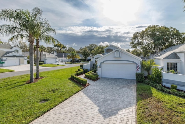 1084 Vista Fina Ct, Spring Hill, FL 34608 - view of front of property featuring decorative driveway, a front lawn, an attached garage, a residential view, and stucco siding