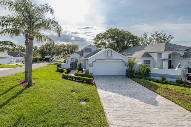 1084 Vista Fina Ct, Spring Hill, FL 34608 - view of front facade featuring decorative driveway, an attached garage, stucco siding, and a front yard