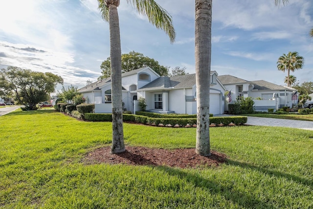 1084 Vista Fina Ct, Spring Hill, FL 34608 - view of front facade with a garage, driveway, stucco siding, and a front yard