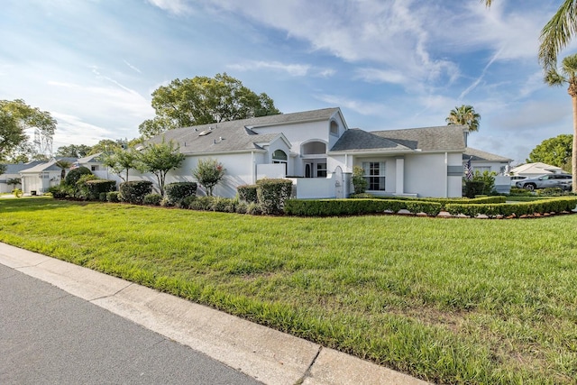 1084 Vista Fina Ct, Spring Hill, FL 34608 - view of front of property featuring stucco siding, a front lawn, and a shingled roof