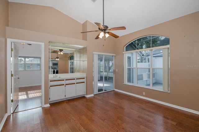 1084 Vista Fina Ct, Spring Hill, FL 34608 - spare room with a ceiling fan, dark wood-style floors, lofted ceiling, baseboards, and a sink