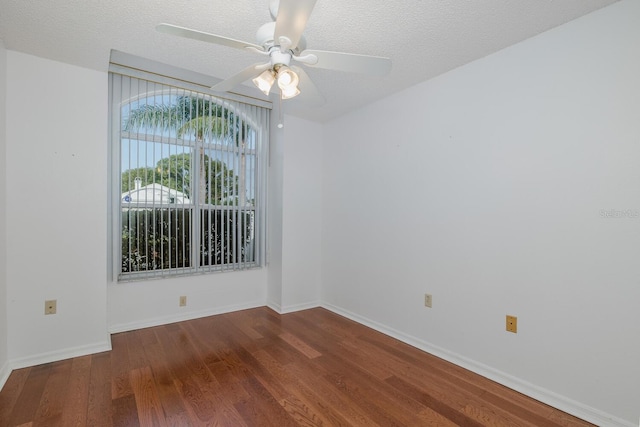 1084 Vista Fina Ct, Spring Hill, FL 34608 - unfurnished room featuring wood finished floors, a ceiling fan, a textured ceiling, and baseboards