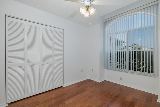 1084 Vista Fina Ct, Spring Hill, FL 34608 - unfurnished bedroom with wood finished floors, baseboards, a closet, and a ceiling fan