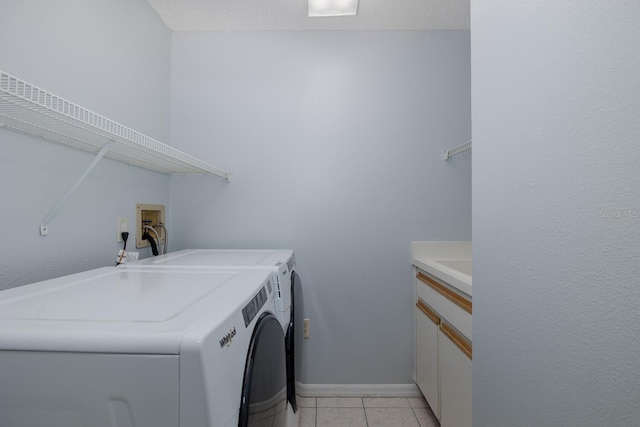 1084 Vista Fina Ct, Spring Hill, FL 34608 - laundry room with independent washer and dryer, light tile patterned floors, baseboards, and cabinet space