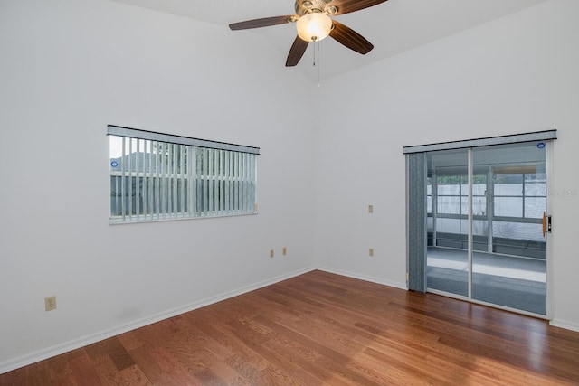 1084 Vista Fina Ct, Spring Hill, FL 34608 - spare room with wood finished floors, baseboards, ceiling fan, and a high ceiling