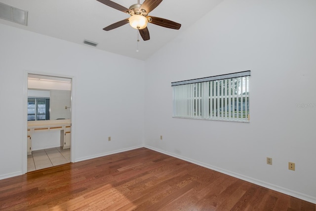 1084 Vista Fina Ct, Spring Hill, FL 34608 - empty room with wood finished floors, a ceiling fan, baseboards, and high vaulted ceiling