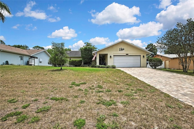 4072 Everett Ave, Spring Hill, FL 34609 - ranch-style home with decorative driveway, an attached garage, and a front lawn