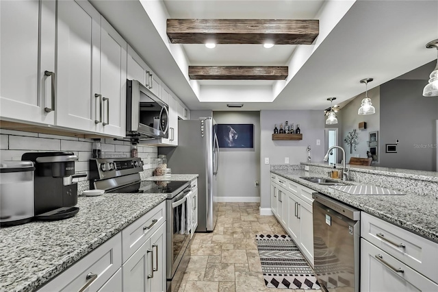 4072 Everett Ave, Spring Hill, FL 34609 - kitchen with stainless steel appliances, baseboards, a sink, a tray ceiling, and decorative backsplash