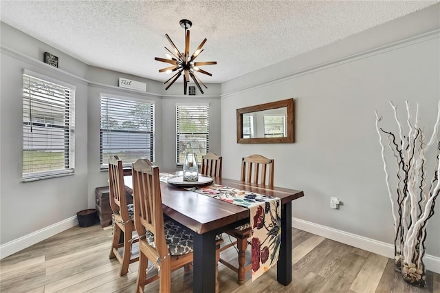 4072 Everett Ave, Spring Hill, FL 34609 - dining area featuring a textured ceiling, light wood-style flooring, baseboards, and a ceiling fan