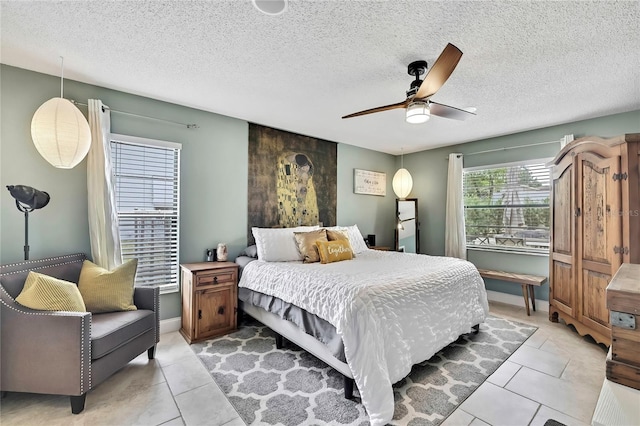 4072 Everett Ave, Spring Hill, FL 34609 - bedroom featuring light tile patterned floors, a textured ceiling, and ceiling fan