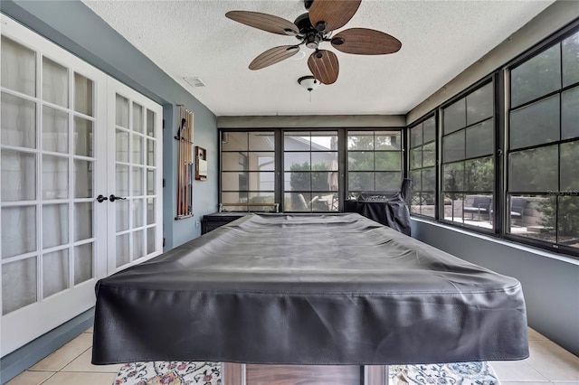 4072 Everett Ave, Spring Hill, FL 34609 - rec room with tile patterned floors, a textured ceiling, ceiling fan, plenty of natural light, and french doors