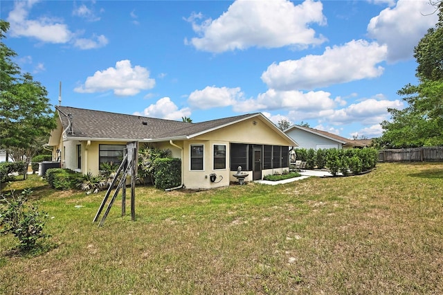 4072 Everett Ave, Spring Hill, FL 34609 - rear view of house with stucco siding, a sunroom, and central AC
