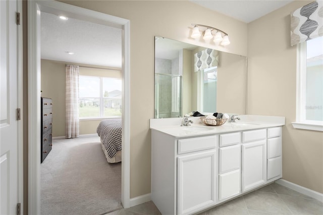 8921 Waxwing Way, Parrish, FL 34219 - ensuite bathroom with double vanity, an enclosed shower, and baseboards