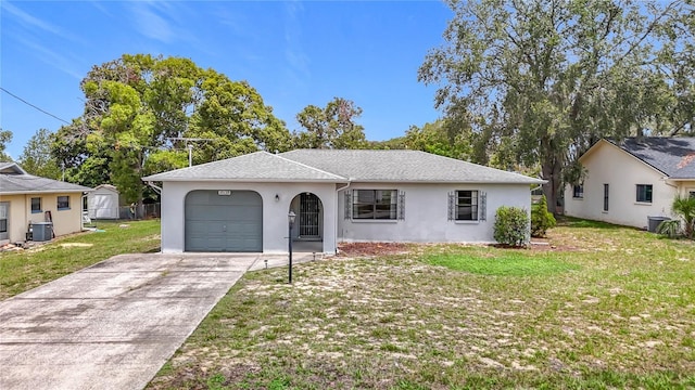 10139 Carrin Rd, Spring Hill, FL 34608 - view of front of house with a garage, stucco siding, a front lawn, central AC unit, and concrete driveway