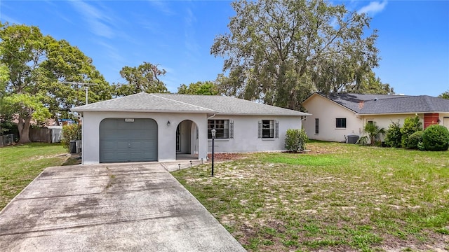 10139 Carrin Rd, Spring Hill, FL 34608 - single story home with stucco siding, a front yard, a garage, and driveway