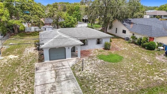 10139 Carrin Rd, Spring Hill, FL 34608 - view of front of home featuring roof with shingles, stucco siding, an attached garage, and driveway