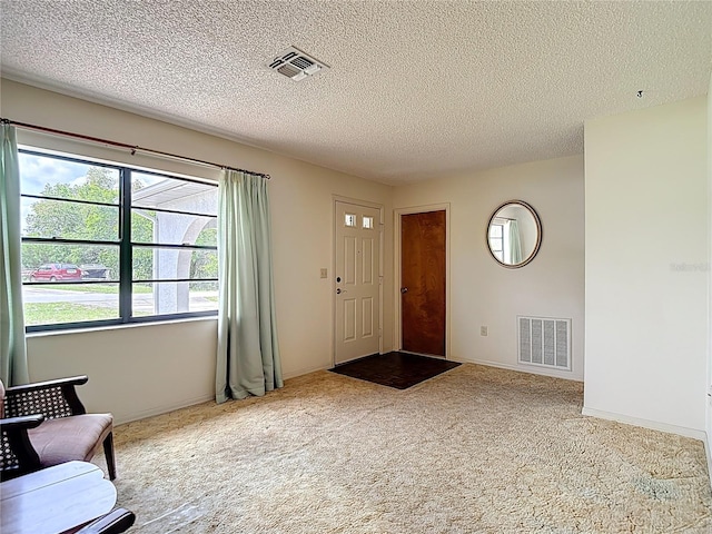 10139 Carrin Rd, Spring Hill, FL 34608 - carpeted foyer featuring a textured ceiling and baseboards