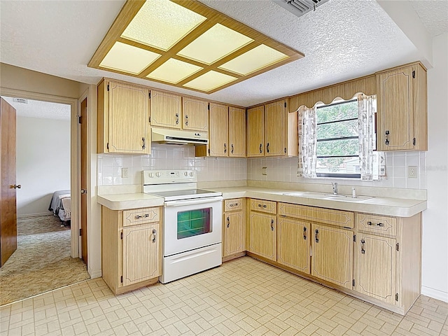 10139 Carrin Rd, Spring Hill, FL 34608 - kitchen with white range with electric stovetop, under cabinet range hood, light countertops, a sink, and backsplash