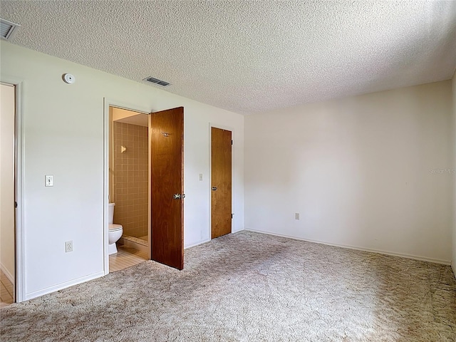 10139 Carrin Rd, Spring Hill, FL 34608 - unfurnished bedroom with carpet floors, a textured ceiling, ensuite bath, and baseboards
