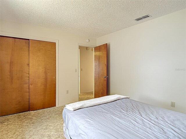 10139 Carrin Rd, Spring Hill, FL 34608 - carpeted bedroom featuring a closet and a textured ceiling