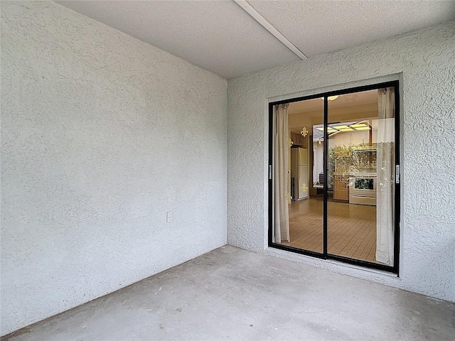 10139 Carrin Rd, Spring Hill, FL 34608 - spare room with a textured wall and unfinished concrete floors
