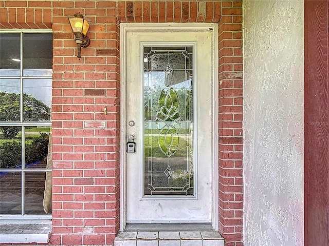 11340 Corinthian St, Spring Hill, FL 34609 - view of exterior entry featuring brick siding