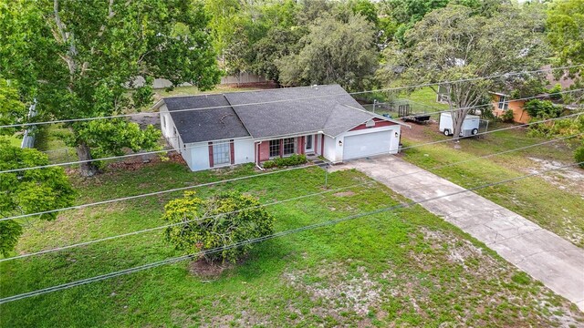 11340 Corinthian St, Spring Hill, FL 34609 - view of front of home featuring an attached garage, concrete driveway, and a shingled roof