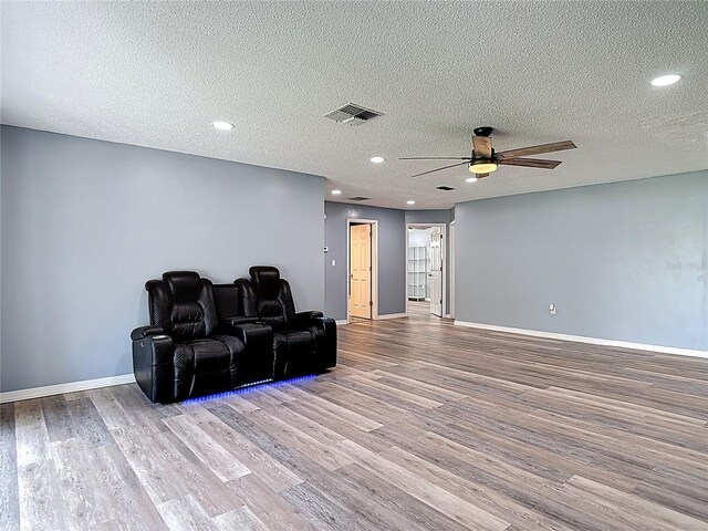 11340 Corinthian St, Spring Hill, FL 34609 - cinema featuring a ceiling fan, wood finished floors, baseboards, a textured ceiling, and recessed lighting