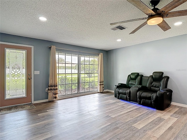 11340 Corinthian St, Spring Hill, FL 34609 - cinema room with wood finished floors, a ceiling fan, recessed lighting, a textured ceiling, and baseboards