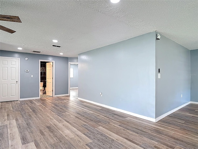 11340 Corinthian St, Spring Hill, FL 34609 - unfurnished living room with wood finished floors, a textured ceiling, baseboards, recessed lighting, and ceiling fan